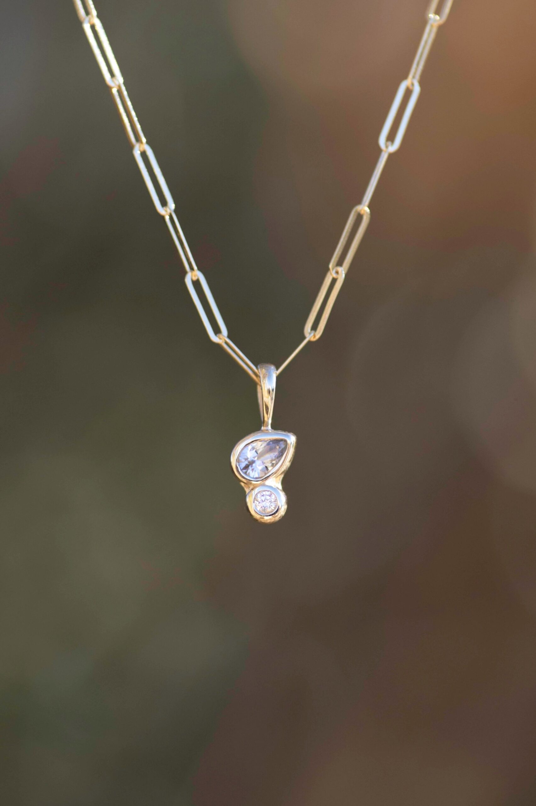 Diamond and White Sapphire Pendant in 14k Gold